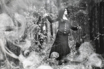 Obraz premium Woman in a witch suit in a dense forest