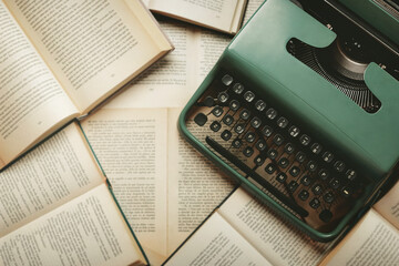 Top view of vintage typewriter with books and copy space