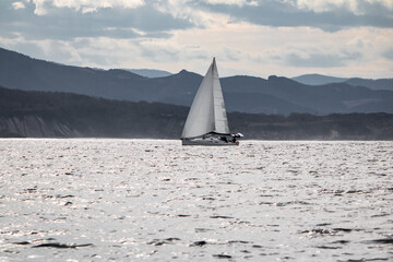 Fototapeta na wymiar beautiful sailing boat cruising atlantic ocean on basque coastline, hendaye, france