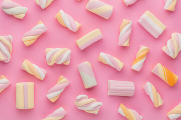 Colorful marshmallows on pastel background.