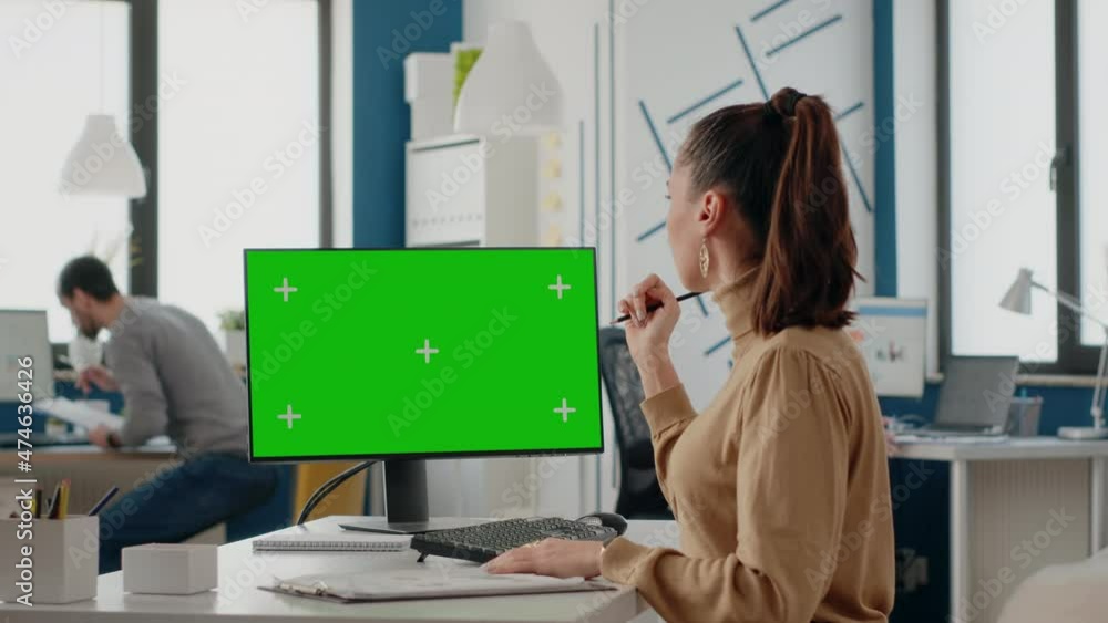 Poster colleagues working together with green screen on computer display. business women looking at compute