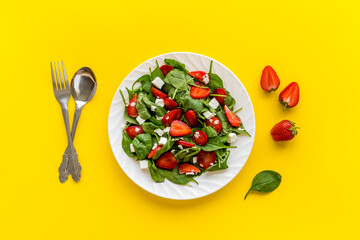 Fresh fruit salad with spinach and strawberry. Healthy happy meal