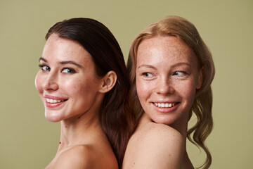 Two diverse girl with different skin condition smiling toothy