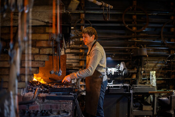 Blacksmith at work, hit with a hammer by a hot metal on the anvil.