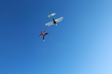 Naklejka na ściany i meble Skydiving. Skydiver dressed as Santa Claus flies in the sky.