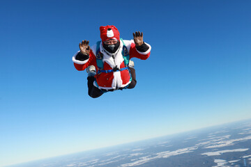 Skydiving. The jump before New Year. Skydiver dressed as Santa Claus.