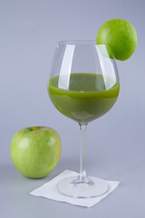 Fototapeta na wymiar Healthy, fresh apple juice in tall glass on grey background 