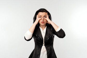 Surprised shocked businesswoman in black formal jacket white shirt, standing over white background. Business concept