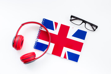 Notebook with British flag and headphones. English lessons concept