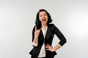 Attractive cool businesswoman making horn sign hand gesture, standing over white background
