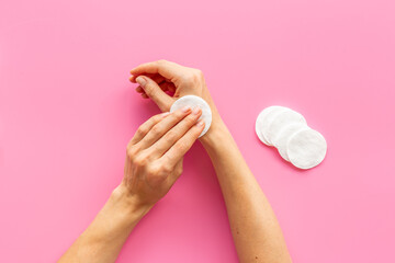 Female hands holding cotton pads for cleansing skin and care