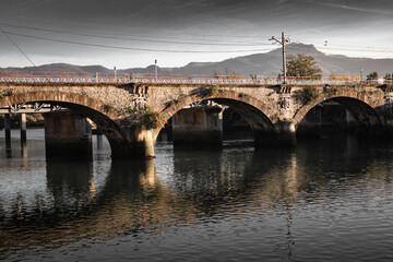 Fototapeta premium Old Bridge Saint Jacques over river Bidassoa on border with France and Spain