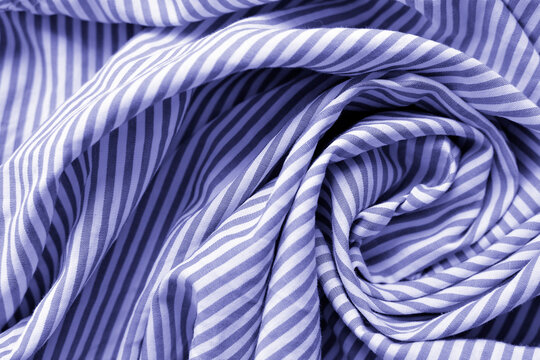 Very peri color of the year 2022. Striped fabric. Cotton, bedding, blue and white stripes on the fabric. Texture. Background.