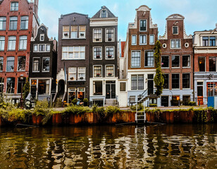 Fototapeta na wymiar Amsterdam cute city with channels, bridges, old buildings, European architecture, Holland 