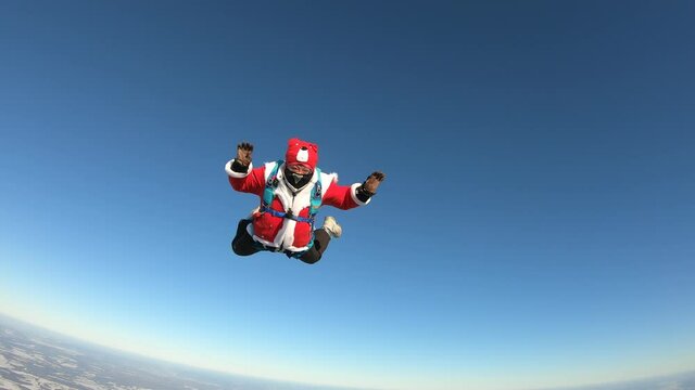 Skydiving. Skydiver dressed as Santa Claus is flying in the sky.