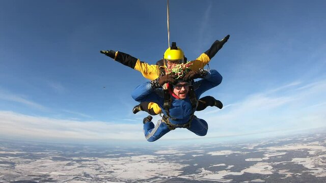 Skydiving. Tandem jump. Two men are flying in the sky.