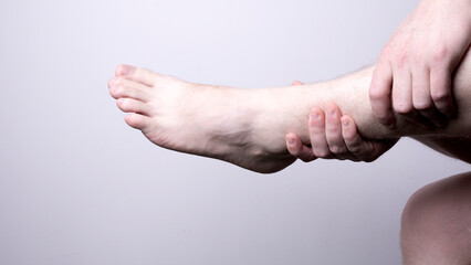 Leg pain, man suffering from leg pain, podiatry concept