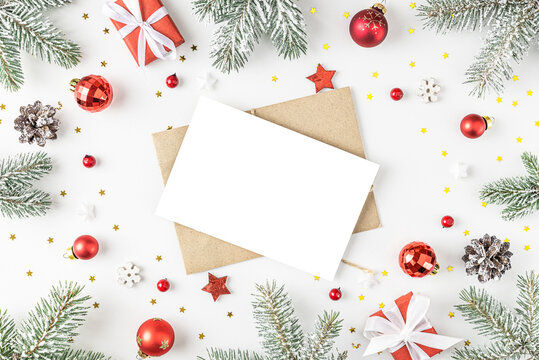Christmas or Happy New Year greeting card in frame made of fir tree branches, holiday decorations