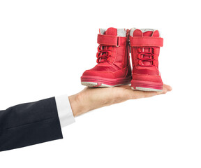Hand with child shoes