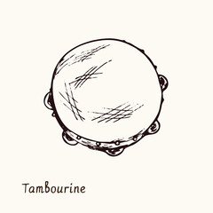 Tambourine. Ink black and white doodle drawing in woodcut style with inscription.