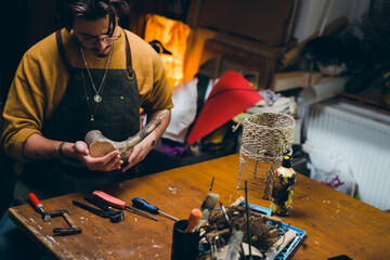 close up man working with wood in his workshop