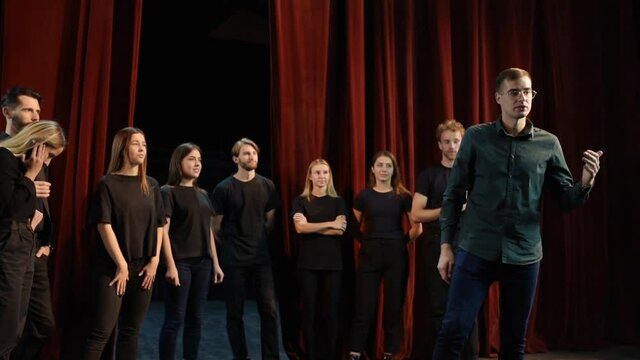Group of young artists is together on the theater stage have rehearsal