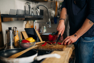 man cutting vegetables and preparing salad