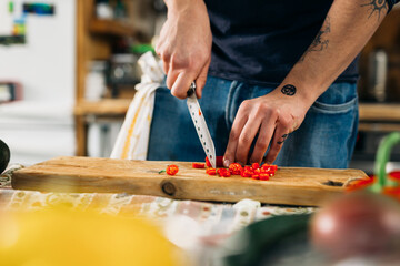 man cutting vegetables and preparing salad