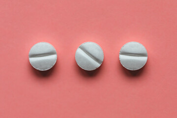 Pills on pink background, supplement and medicine concept. Closeup, copy space