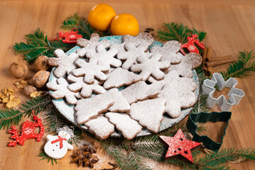 Christmas gingerbread cookies on a table decorated with New Year decorations, front view