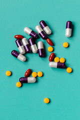 Pills and capsules on a green background