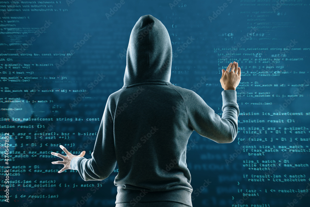 Fototapete Back view of hacker in hoodie on abstract coding background. Hacking and technology concept.