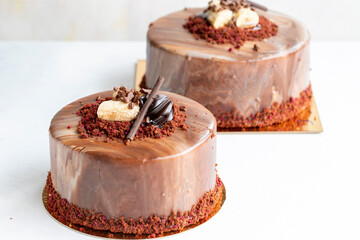 Banana and chocolate cake on a white background. Horizontal view. Close-up celebration cake