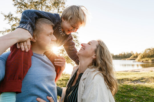 Happy family enjoying sunset at park