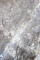 Cracked plaster wall texture, damaged walls exposed to sunlight and rain