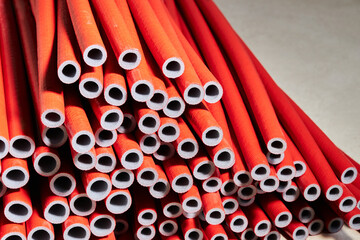 Thermal insulation PE foam for covering pipes. Red PE foam insulation tube