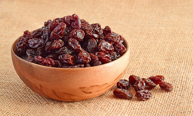 Dried raisins on the sack background