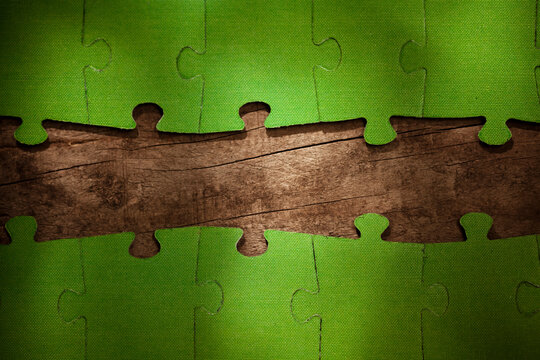Incomplete green jigsaw puzzle pieces on table