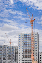 Fototapeta na wymiar Hoisting crane and building of houses