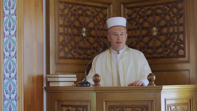 Muslim cleric preparing to preach to the congregation at the mosque for Friday prayers. The Muslim cleric will explain to the congregation what it takes to be a good Muslim.