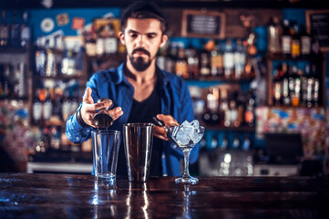 Barman makes a cocktail on the alehouse