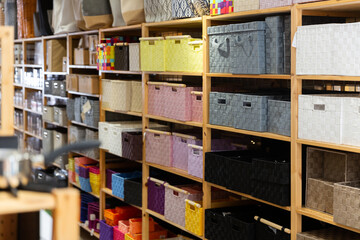 Shelf with colored storage baskets for sell in a household goods store