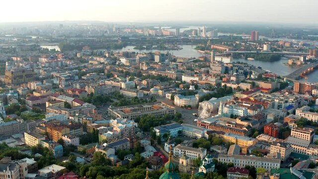 Top view of Podol. Many buildings and churches. Evening view of the river Dnipro.