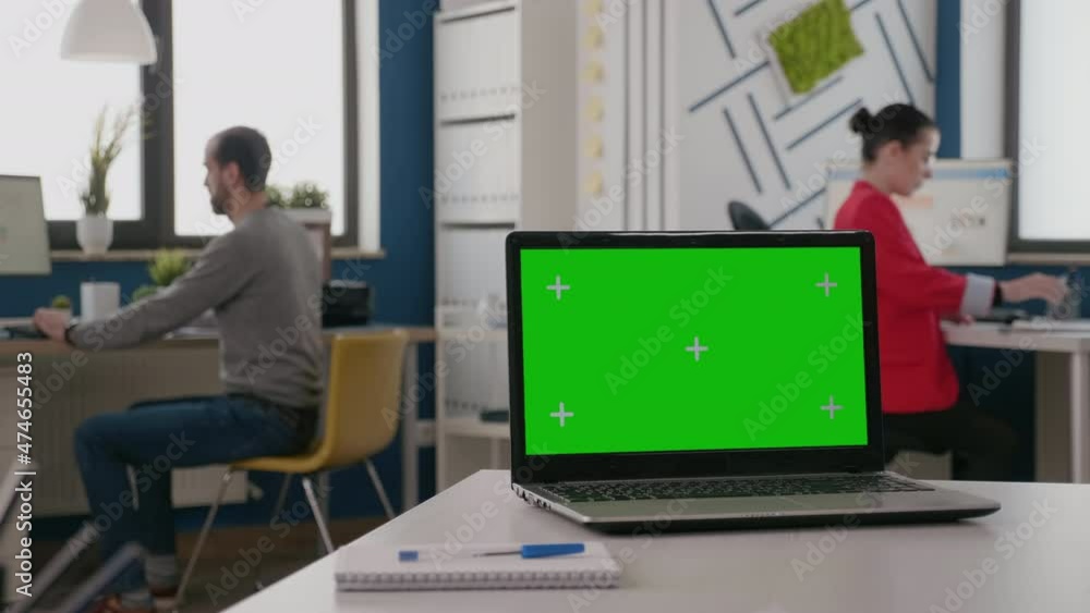 Poster close up of isolated green screen on laptop at empty desk. device with mock up template and chroma k