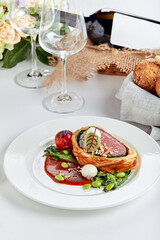 Meat roll sliced on a dish with vegetables on a festive table