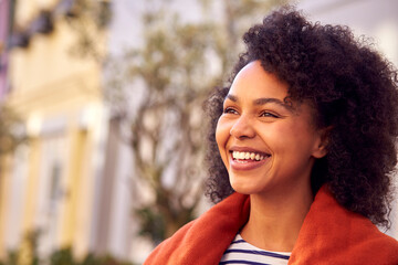 Outdoor Head And Shoulders Portrait Of Smiling Woman Wearing Coat And Scarf In Autumn Or Fall