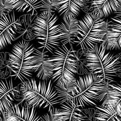 Seamless pattern of palm leaves and monstera. White leaves on a black background. Abstract plant art design with palm leaves. Tropical botanical pattern. Elegant vector print for your design.
