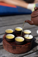 Tea ceremony, Woman pouring traditionally prepared tea