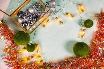 magic garland - Toy Christmas trees in glass jars and green grass balls, on a blue background. a...