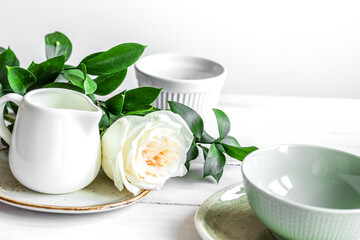 ceramic tableware with flowers on white background